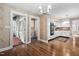 Open kitchen with wood floors, granite countertops, white cabinets, and an eat-in breakfast nook at 212 W University Dr, Chapel Hill, NC 27516