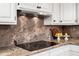 Modern kitchen with custom backsplash and updated appliances at 212 W University Dr, Chapel Hill, NC 27516