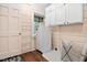 Laundry area with built-in cabinets and shelves for ample storage and convenience at 212 W University Dr, Chapel Hill, NC 27516