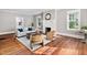Sun-drenched living room features hardwood floors, a fireplace, and modern furnishings at 212 W University Dr, Chapel Hill, NC 27516