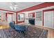 Cozy living room with hardwood floors, fireplace, built-in shelving, and ample seating at 212 W University Dr, Chapel Hill, NC 27516