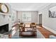 Bright living room with fireplace, hardwood floors, and stylish decor at 212 W University Dr, Chapel Hill, NC 27516