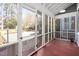 Enclosed porch featuring multiple windows and a view of the yard at 212 W University Dr, Chapel Hill, NC 27516