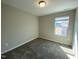 A cozy bedroom featuring neutral tones, plush carpet, and a window that offers natural light, creating a serene atmosphere at 219 Adobe Pl, Cary, NC 27519