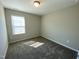 Serene bedroom featuring a large window, neutral decor, and plush carpeting, creating a peaceful retreat at 219 Adobe Pl, Cary, NC 27519