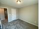 Comfortable bedroom with neutral walls, plush carpeting, and ample space for personalization and relaxation at 219 Adobe Pl, Cary, NC 27519
