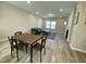 Bright dining area with modern table set, seamlessly connected to the living room, great for Gathering gatherings at 219 Adobe Pl, Cary, NC 27519