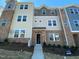 Modern townhome featuring a brick facade, multi-pane windows, and a welcoming entrance at 219 Adobe Pl, Cary, NC 27519