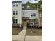 Inviting townhome featuring a mix of brick and siding, with a neatly landscaped front yard and a bright, welcoming entrance at 219 Adobe Pl, Cary, NC 27519