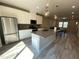 Modern kitchen with stainless steel appliances, a large island, and stylish pendant lighting, adjacent to dining area at 219 Adobe Pl, Cary, NC 27519