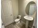 Powder room featuring a pedestal sink, modern fixtures, and a clean, contemporary design at 219 Adobe Pl, Cary, NC 27519