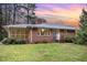 Charming brick home with a beautiful sunset sky providing excellent curb appeal at 2246 Hillandale Rd, Durham, NC 27705