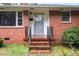 Inviting front entrance with classic brick steps and black railing at 2246 Hillandale Rd, Durham, NC 27705