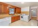 Functional kitchen with appliances, wood cabinetry, and lots of counter space at 2246 Hillandale Rd, Durham, NC 27705