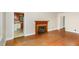 Spacious living room featuring original hardwood floors and a charming fireplace at 2246 Hillandale Rd, Durham, NC 27705