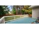 A nice backyard view from deck featuring a wooden fence, lawn, and mature trees for privacy at 2429 Falls River Ave, Raleigh, NC 27614