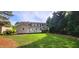 Beautiful backyard featuring a lawn, deck, and mature trees at 2429 Falls River Ave, Raleigh, NC 27614