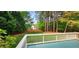 View from deck to the spacious backyard with a wooden fence and mature trees for privacy at 2429 Falls River Ave, Raleigh, NC 27614