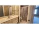 Bathroom featuring a vanity with a mirror and a shower/tub combination with a curtain at 2429 Falls River Ave, Raleigh, NC 27614