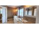 Primary bathroom features granite counters, a soaking tub, and separate vanities at 2429 Falls River Ave, Raleigh, NC 27614