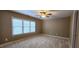 Carpeted bedroom featuring a double window and a ceiling fan at 2429 Falls River Ave, Raleigh, NC 27614