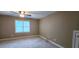 Carpeted bedroom featuring a window and a ceiling fan at 2429 Falls River Ave, Raleigh, NC 27614