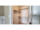 Walk-in closet featuring carpeted floors, shelving, and hanging rods at 2429 Falls River Ave, Raleigh, NC 27614