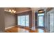 Charming dining room with chandelier, hardwood floors, and bright window at 2429 Falls River Ave, Raleigh, NC 27614