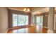 Dining room featuring hardwood floors, chandelier, and large window at 2429 Falls River Ave, Raleigh, NC 27614