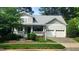 Charming home with manicured lawn, covered porch, and two-car garage at 2429 Falls River Ave, Raleigh, NC 27614