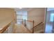 Upstairs hallway with carpet and railing overlooking the lower level at 2429 Falls River Ave, Raleigh, NC 27614