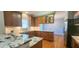 Modern kitchen with granite counters, stainless appliances, and wooden cabinets at 2429 Falls River Ave, Raleigh, NC 27614
