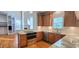 Open kitchen with stainless steel appliances and granite countertops overlooks the living space at 2429 Falls River Ave, Raleigh, NC 27614