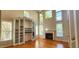 Bright living room with hardwood floors, fireplace, and built in shelving at 2429 Falls River Ave, Raleigh, NC 27614