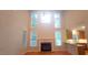 Bright living room with fireplace, hardwood floors, and large windows at 2429 Falls River Ave, Raleigh, NC 27614
