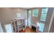 Bright living room featuring hardwood floors, a fireplace, and built-in shelving with many windows at 2429 Falls River Ave, Raleigh, NC 27614