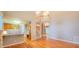 Spacious living room with hardwood floors, staircase and breakfast bar open to kitchen at 2429 Falls River Ave, Raleigh, NC 27614