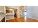 Bright living room featuring hardwood floors, natural light, staircase, and kitchen access at 2429 Falls River Ave, Raleigh, NC 27614