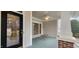 Inviting front porch with black door, painted wood flooring, and ceiling fan at 2429 Falls River Ave, Raleigh, NC 27614
