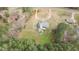 An aerial view showcasing the house nestled in a natural setting, complete with a spacious yard and stock tank pool at 2505 Egypt Mountain Rd, Kittrell, NC 27544