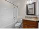 Bathroom featuring a shower-tub combo, toilet, granite countertop, and vanity at 2505 Egypt Mountain Rd, Kittrell, NC 27544