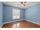 Bedroom with hardwood floors, a ceiling fan, and a window at 2505 Egypt Mountain Rd, Kittrell, NC 27544