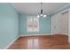 Inviting dining room with hardwood floors, soft blue walls, and elegant chandelier at 2505 Egypt Mountain Rd, Kittrell, NC 27544