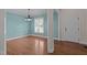 Inviting dining room with hardwood floors, soft blue walls, and elegant chandelier at 2505 Egypt Mountain Rd, Kittrell, NC 27544
