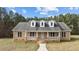 Charming brick home with three dormer windows, covered porch, and beautiful landscaping at 2505 Egypt Mountain Rd, Kittrell, NC 27544
