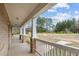 Covered porch with brick columns, providing outdoor space to enjoy the view of the large yard at 2505 Egypt Mountain Rd, Kittrell, NC 27544