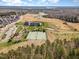 Aerial view showcasing the community, golf course, tennis court, and clubhouse at 251 North Crest Dr, Chapel Hill, NC 27517