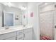Bright bathroom featuring double sinks, a large mirror, and a separate shower area with a patterned curtain at 251 North Crest Dr, Chapel Hill, NC 27517