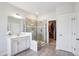 Bright bathroom with dual vanities, tiled shower with glass enclosure, and walk-in closet access at 251 North Crest Dr, Chapel Hill, NC 27517
