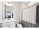 Bright bathroom featuring a modern vanity, toilet, and a shower/tub combo with a shower curtain at 251 North Crest Dr, Chapel Hill, NC 27517